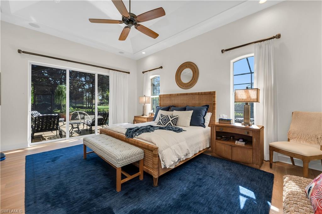 1033 Tierra Lago Way Naples, FL 34119 - Photo 14 of 27 a bedroom with a bed and wooden floor