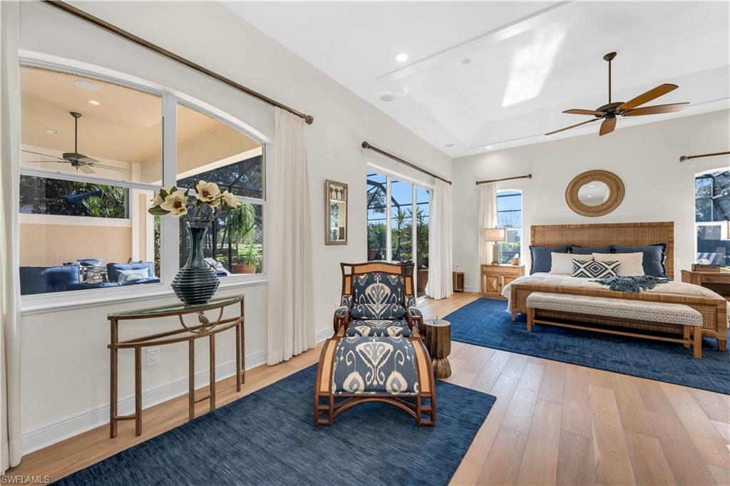 1033 Tierra Lago Way Naples, FL 34119 - Photo 15 of 27 a bedroom with furniture and a large window