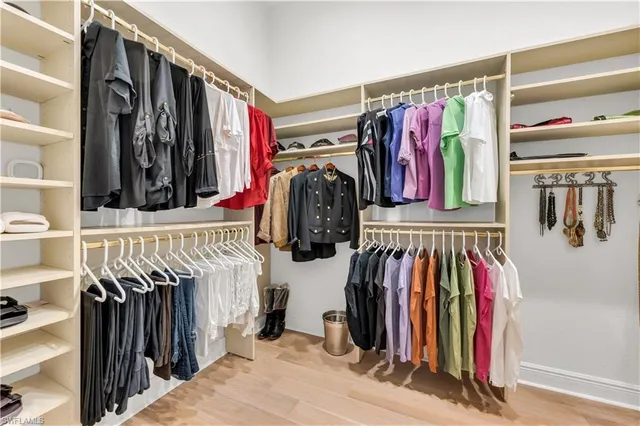 a view of walk in closet with clothes