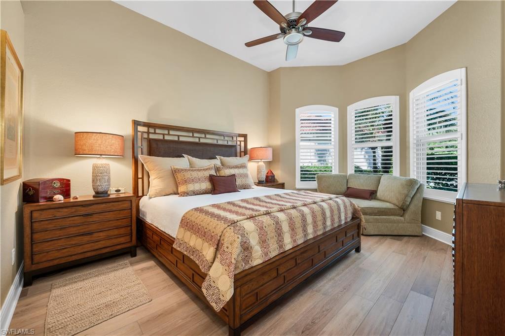 1033 Tierra Lago Way Naples, FL 34119 - Photo 18 of 27 a bed room with a bed and a chandelier