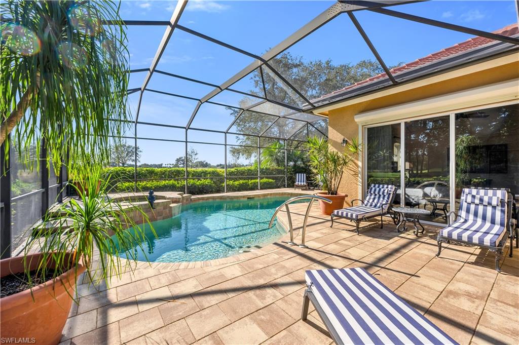 1033 Tierra Lago Way Naples, FL 34119 - Photo 22 of 27 a view of a swimming pool with a patio