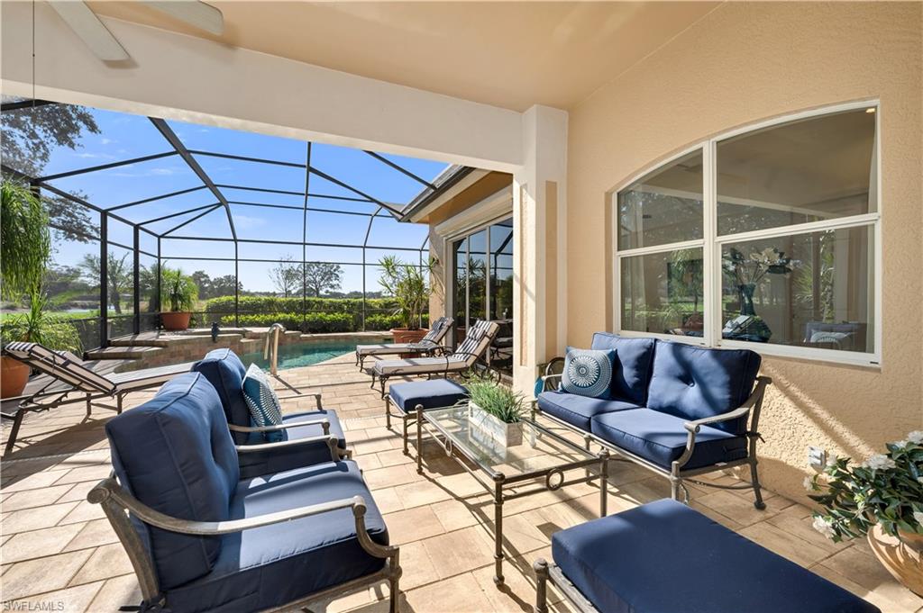 1033 Tierra Lago Way Naples, FL 34119 - Photo 23 of 27 a outdoor living space with patio furniture and a garden