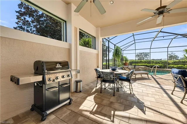 a kitchen with stainless steel appliances kitchen island granite countertop a table and chairs in it