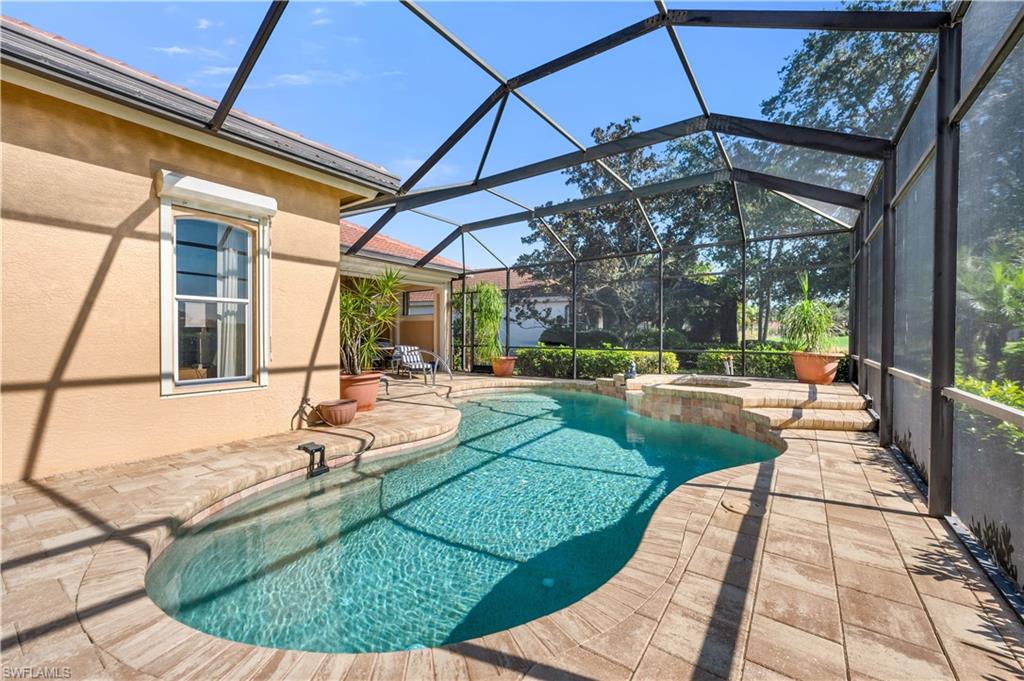 1033 Tierra Lago Way Naples, FL 34119 - Photo 25 of 27 a view of a swimming pool with a patio