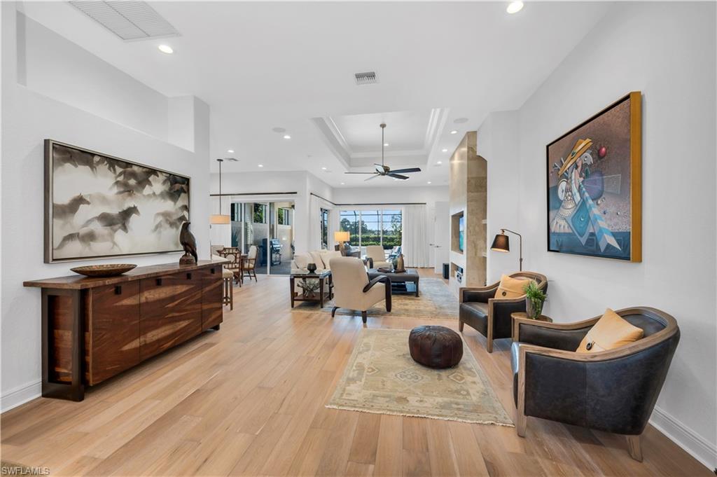 1033 Tierra Lago Way Naples, FL 34119 - Photo 4 of 27 a living room with furniture and wooden floor