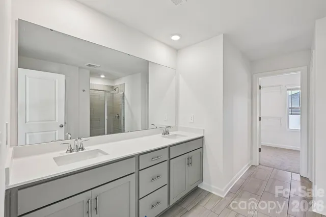 a bathroom with double sink and a mirror