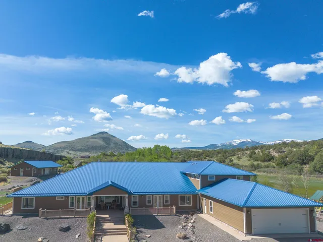 a view of a patio with furniture and a yard