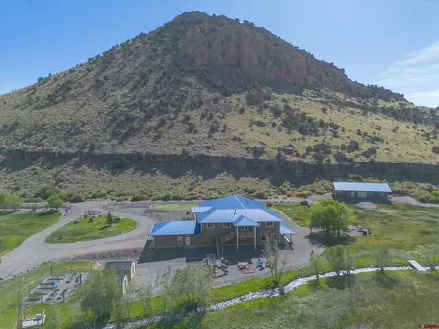 a backyard of a house with a yard and mountain view in back