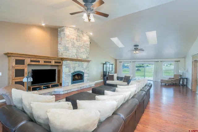 a living room with fireplace furniture a flat screen tv and a fireplace