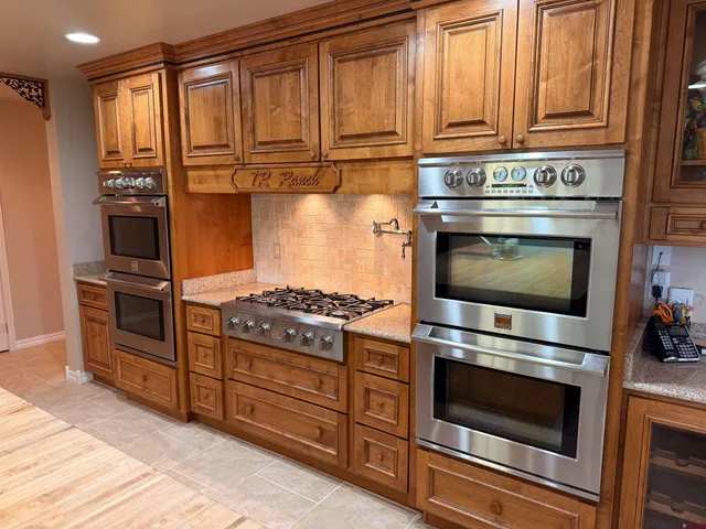 a kitchen with granite countertop a stove and a refrigerator