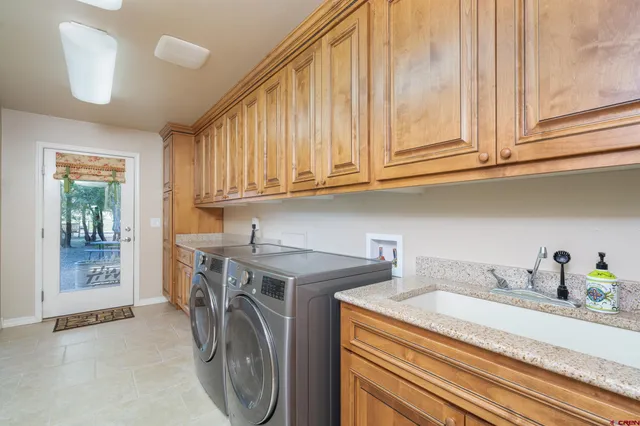 a utility room with sink dryer and washer