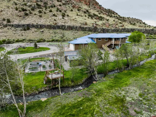 an aerial view of a house with a yard