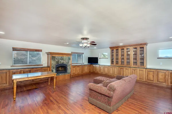 a living room with furniture fireplace and flat screen tv