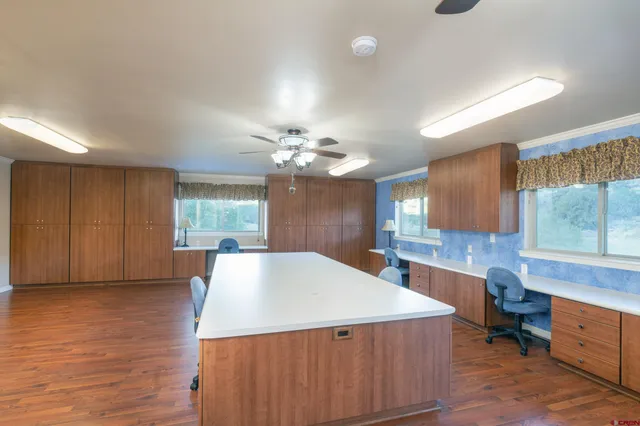 a living room with stainless steel appliances kitchen island granite countertop furniture and a window