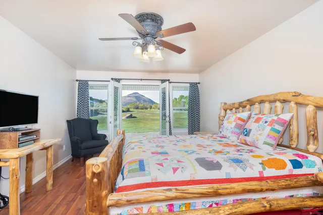 a bedroom with a bed and glass window