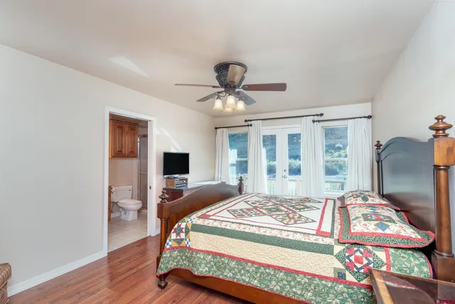 a bedroom with a bed and a chandelier