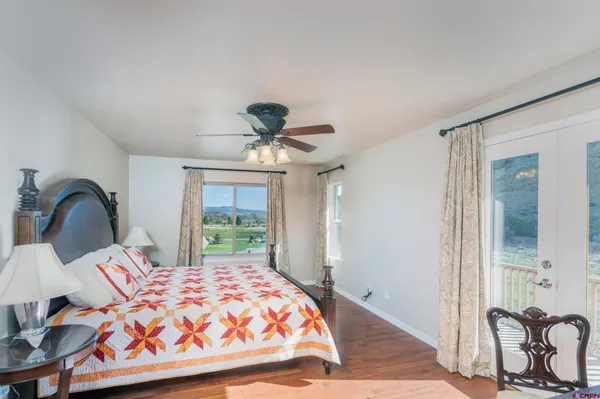 a bedroom with a bed and a dresser with mirror