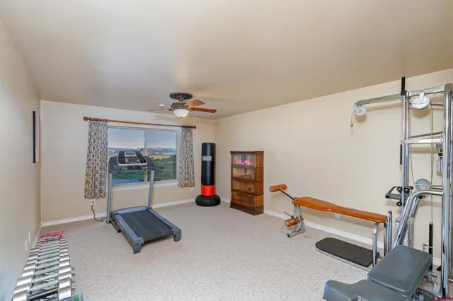 a room with gym equipment and a mirror