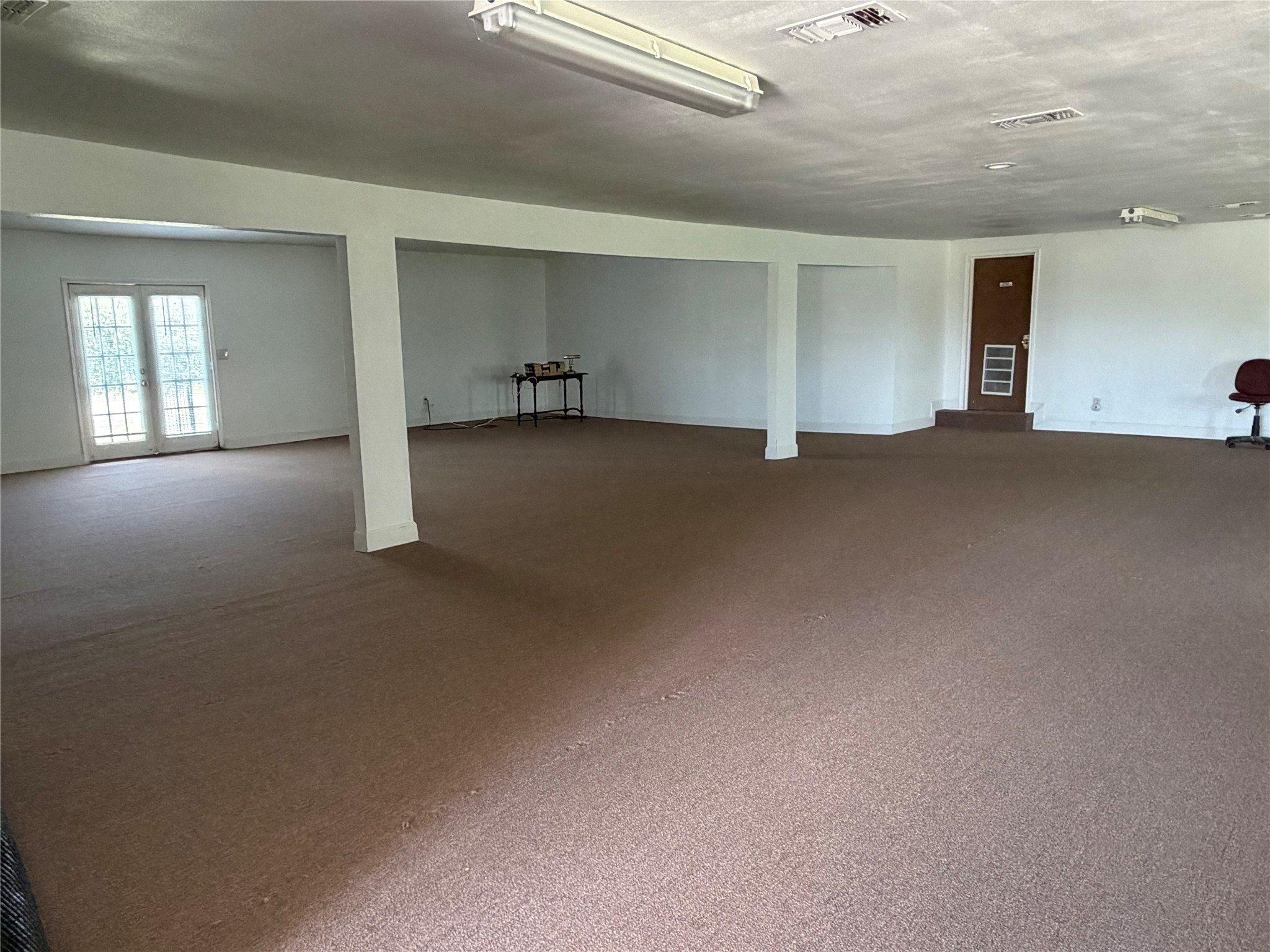 26630 Betka Road Hockley, TX 77447 - Photo 9 of 11 View of main interior space with another set of double doors exit. In the back there’s also 2 separate office spaces.