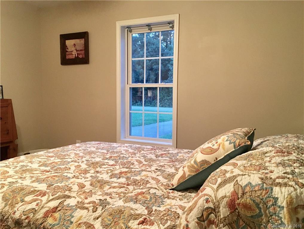 1045 Tabor Road, Unit 21 Olin, NC 28660 - Photo 12 of 23 a bed sitting in a bedroom next to a window