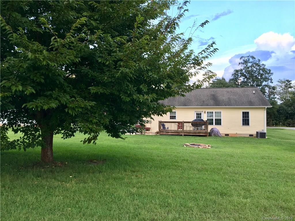 1045 Tabor Road, Unit 21 Olin, NC 28660 - Photo 18 of 23 a view of a house with a big yard and large trees