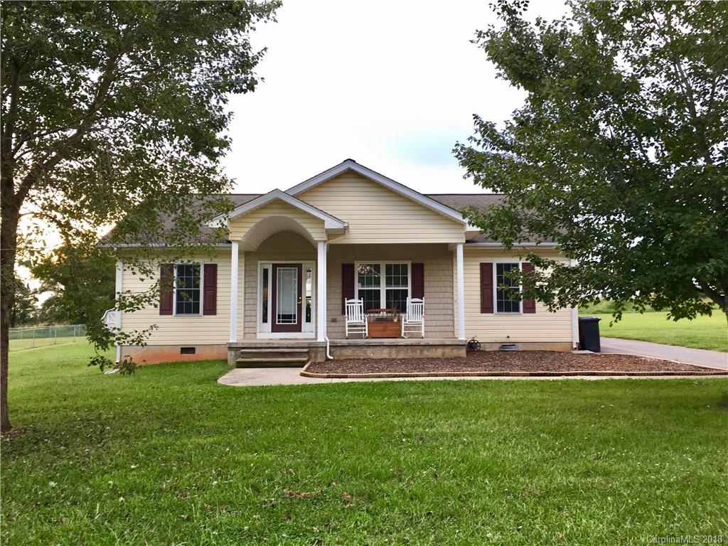 1045 Tabor Road, Unit 21 Olin, NC 28660 - Photo 21 of 23 a front view of house with a garden and trees