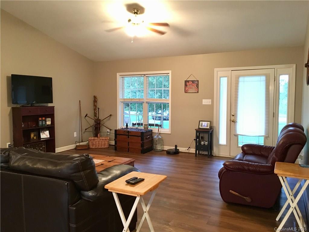 1045 Tabor Road, Unit 21 Olin, NC 28660 - Photo 4 of 23 a living room with fireplace furniture and a flat screen tv