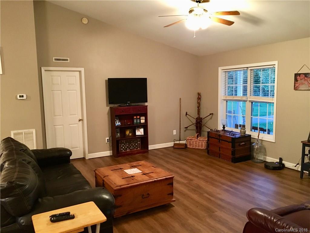 1045 Tabor Road, Unit 21 Olin, NC 28660 - Photo 5 of 23 a living room with furniture and a flat screen tv