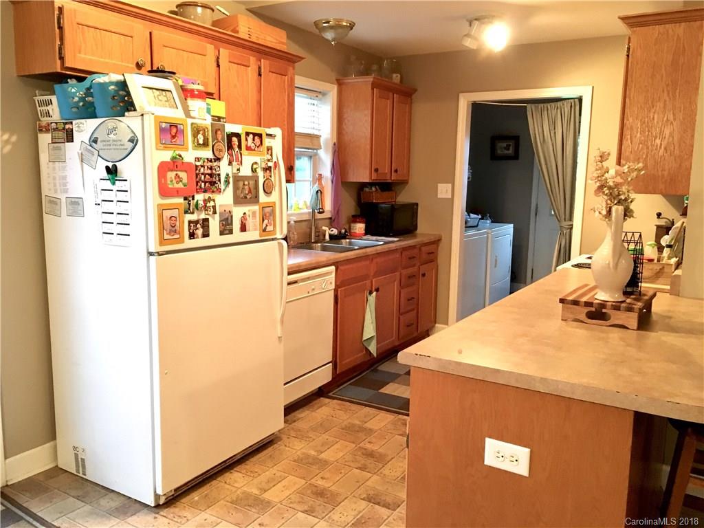 1045 Tabor Road, Unit 21 Olin, NC 28660 - Photo 7 of 23 a kitchen with stainless steel appliances a sink and a refrigerator