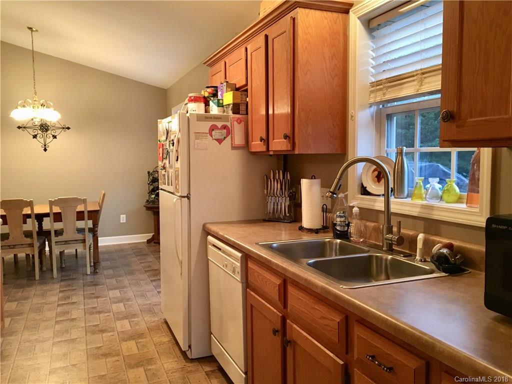 1045 Tabor Road, Unit 21 Olin, NC 28660 - Photo 8 of 23 a kitchen with sink a refrigerator and cabinets