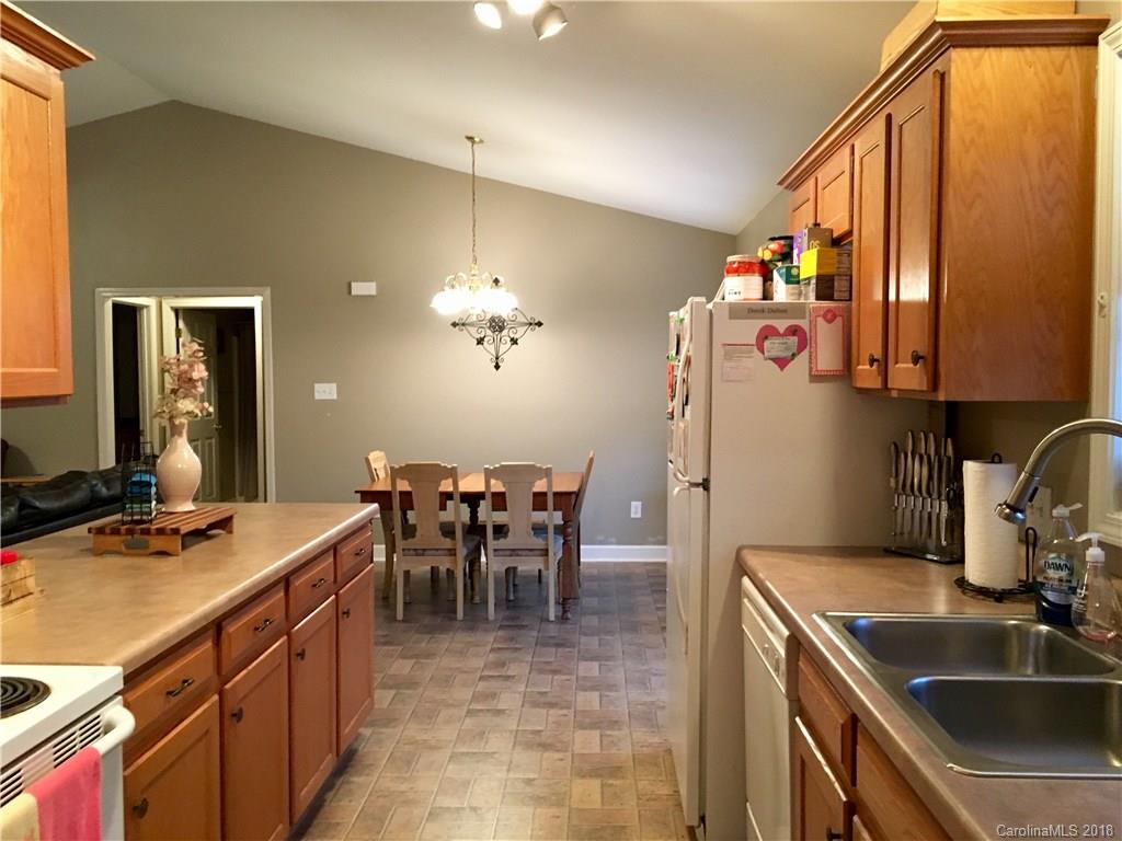 1045 Tabor Road, Unit 21 Olin, NC 28660 - Photo 9 of 23 a kitchen with a sink and cabinets