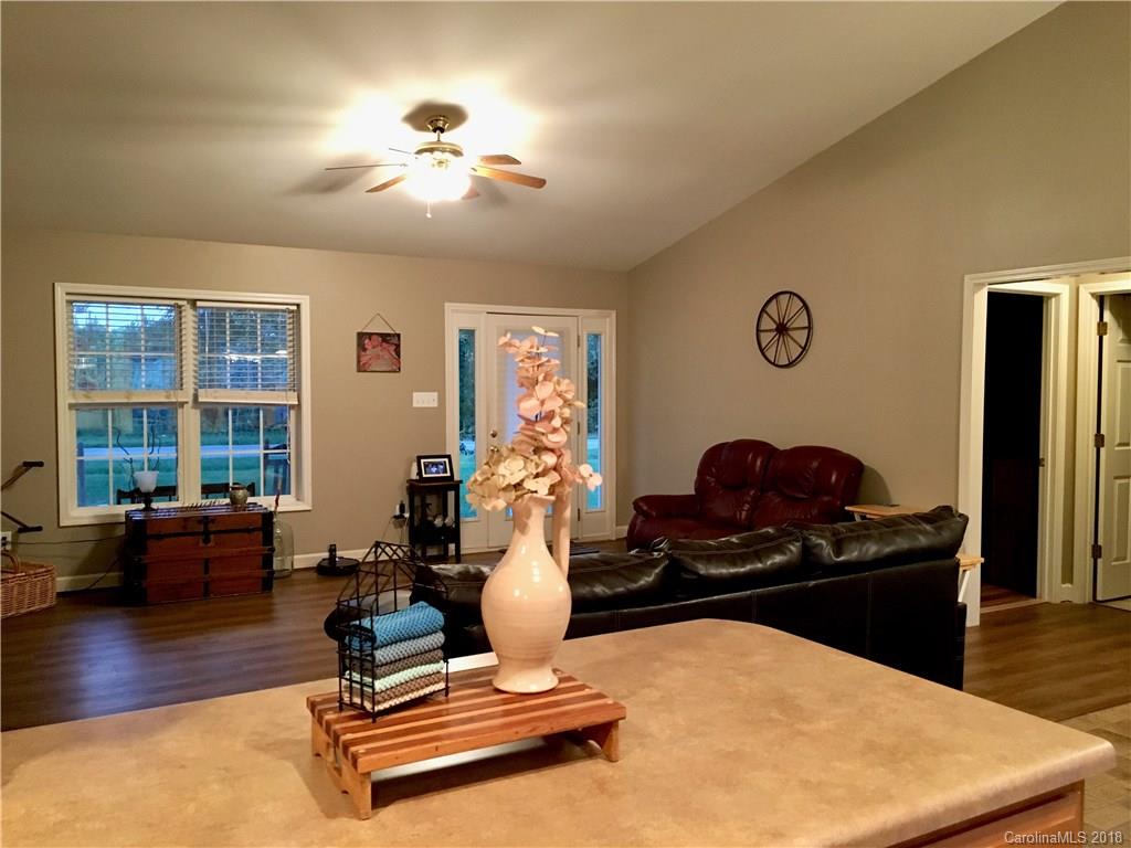 1045 Tabor Road, Unit 21 Olin, NC 28660 - Photo 10 of 23 a living room with furniture gym equipment and a table