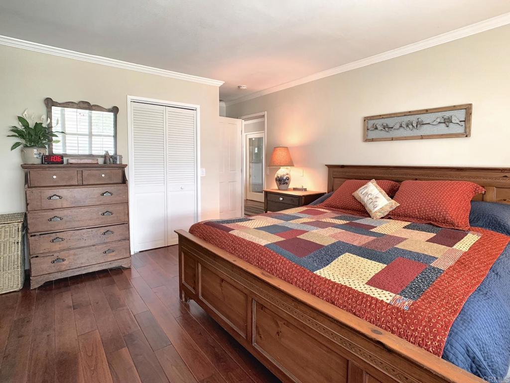 2758 Windmill View Road El Cajon, CA 92020 - Photo 11 of 24 a bedroom with a bed and wooden floor
