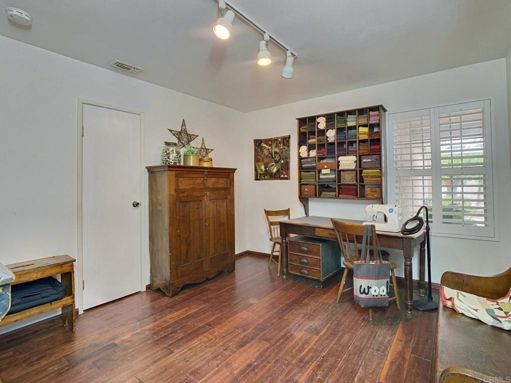2758 Windmill View Road El Cajon, CA 92020 - Photo 12 of 24 a workspace with furniture window and wooden floor