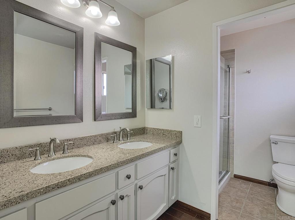 2758 Windmill View Road El Cajon, CA 92020 - Photo 14 of 24 a bathroom with a granite countertop double vanity sink and a mirror