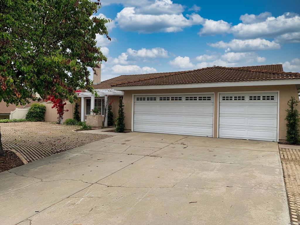 2758 Windmill View Road El Cajon, CA 92020 - Photo 3 of 24 a front view of a house with a yard and garage