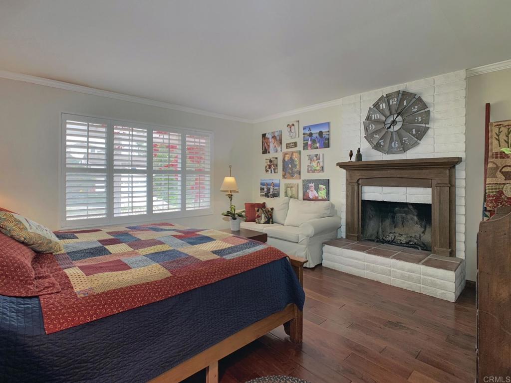 2758 Windmill View Road El Cajon, CA 92020 - Photo 10 of 24 a bedroom with a bed a fireplace and a large window
