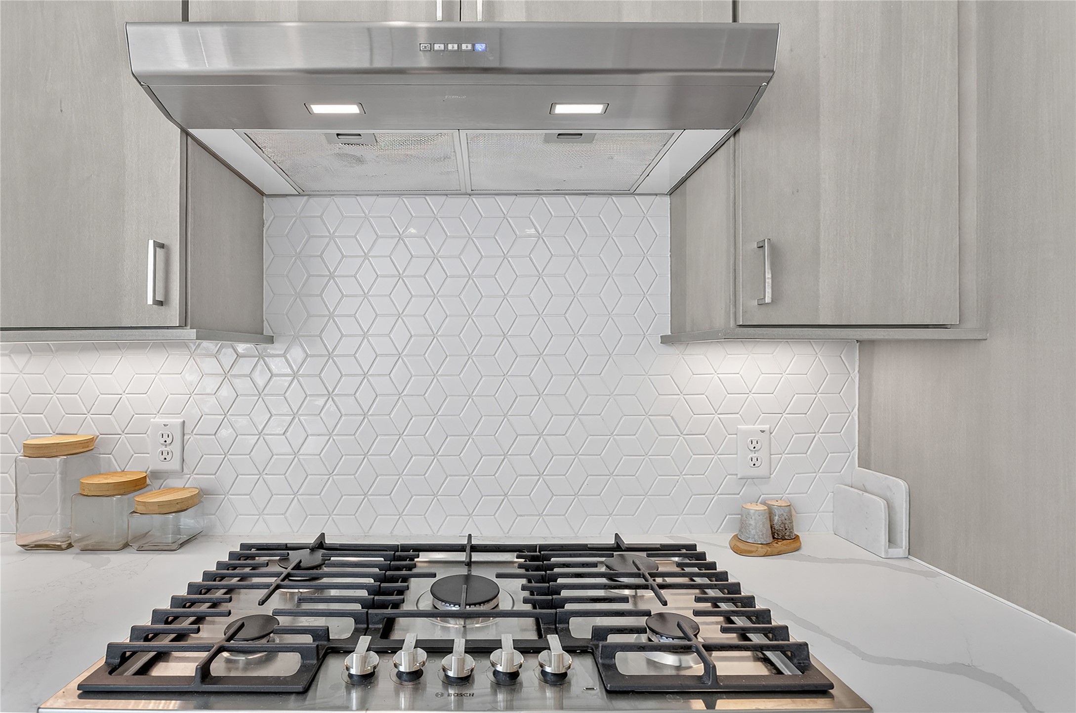 2805 McCurdy Street, Unit 14 Austin, TX 78723 - Photo 12 of 40 Culinary delights await with this modern gas range and geometric tiled backsplash.