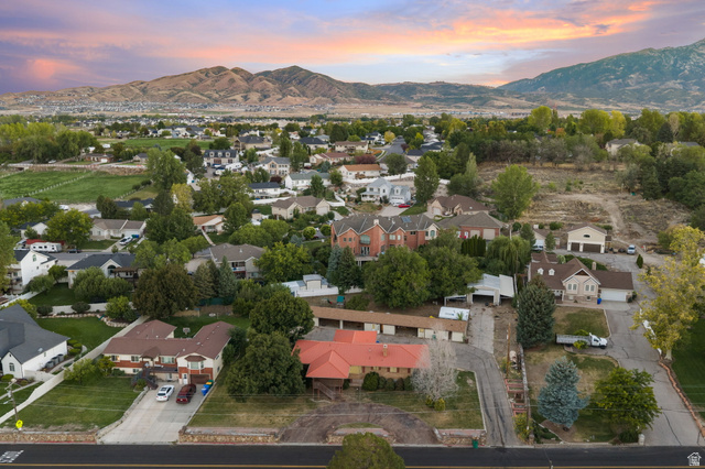 875 Cedar Hollow Road Lehi, UT 84043 - Photo 19 of 76 Residential neighborhood featuring varied architectural styles and mature trees, set against a mountain backdrop