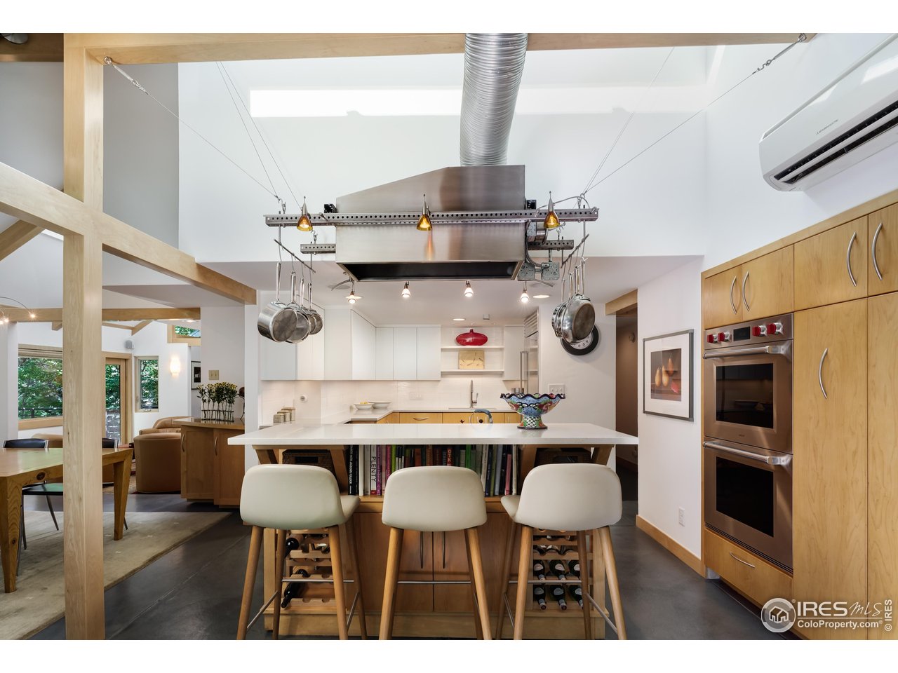 1006 6th Street Boulder, CO 80302 - Photo 11 of 40 a kitchen with stainless steel appliances a table chairs and a refrigerator