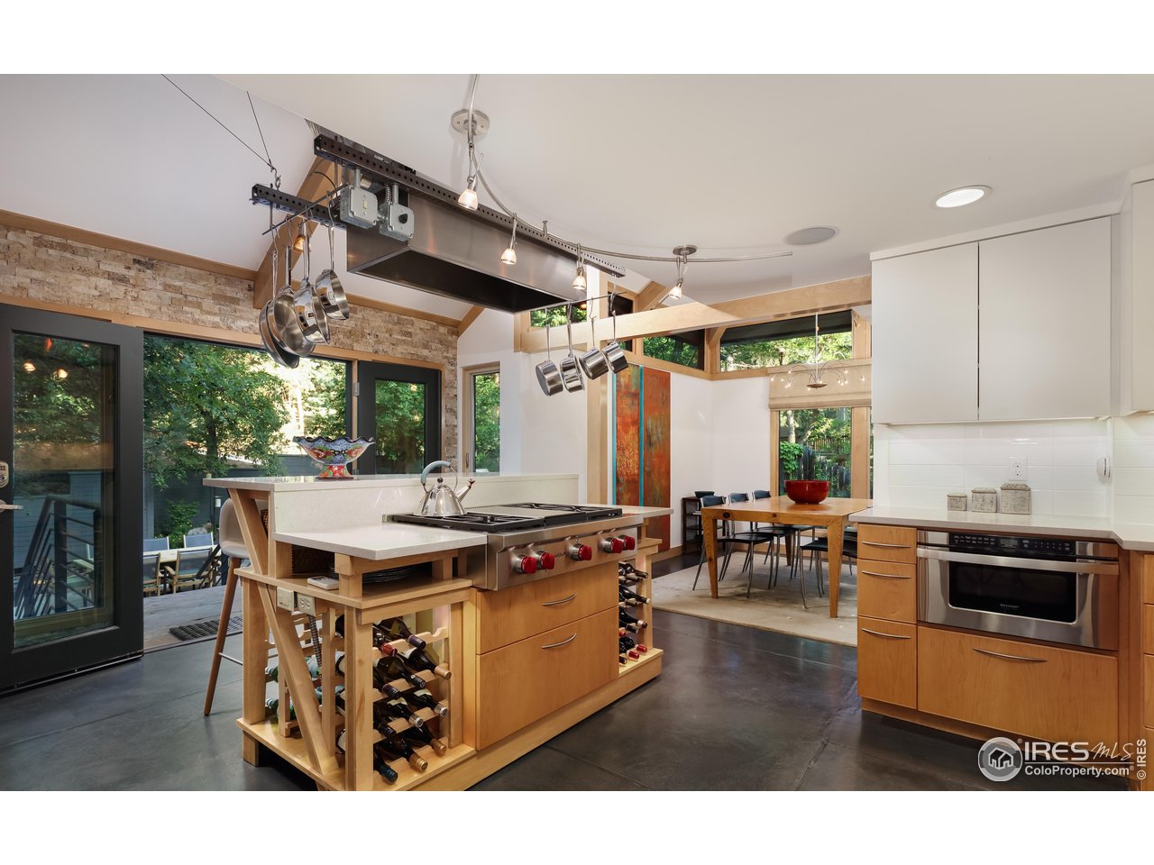 1006 6th Street Boulder, CO 80302 - Photo 16 of 40 a kitchen with a stove a counter space a sink and chairs
