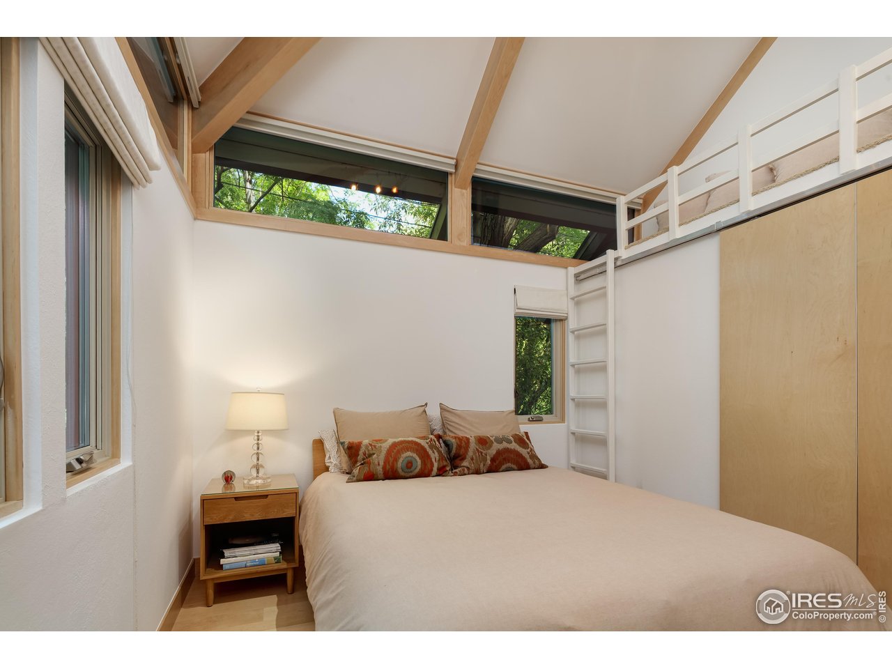 1006 6th Street Boulder, CO 80302 - Photo 20 of 40 a bedroom with a bed and a large window