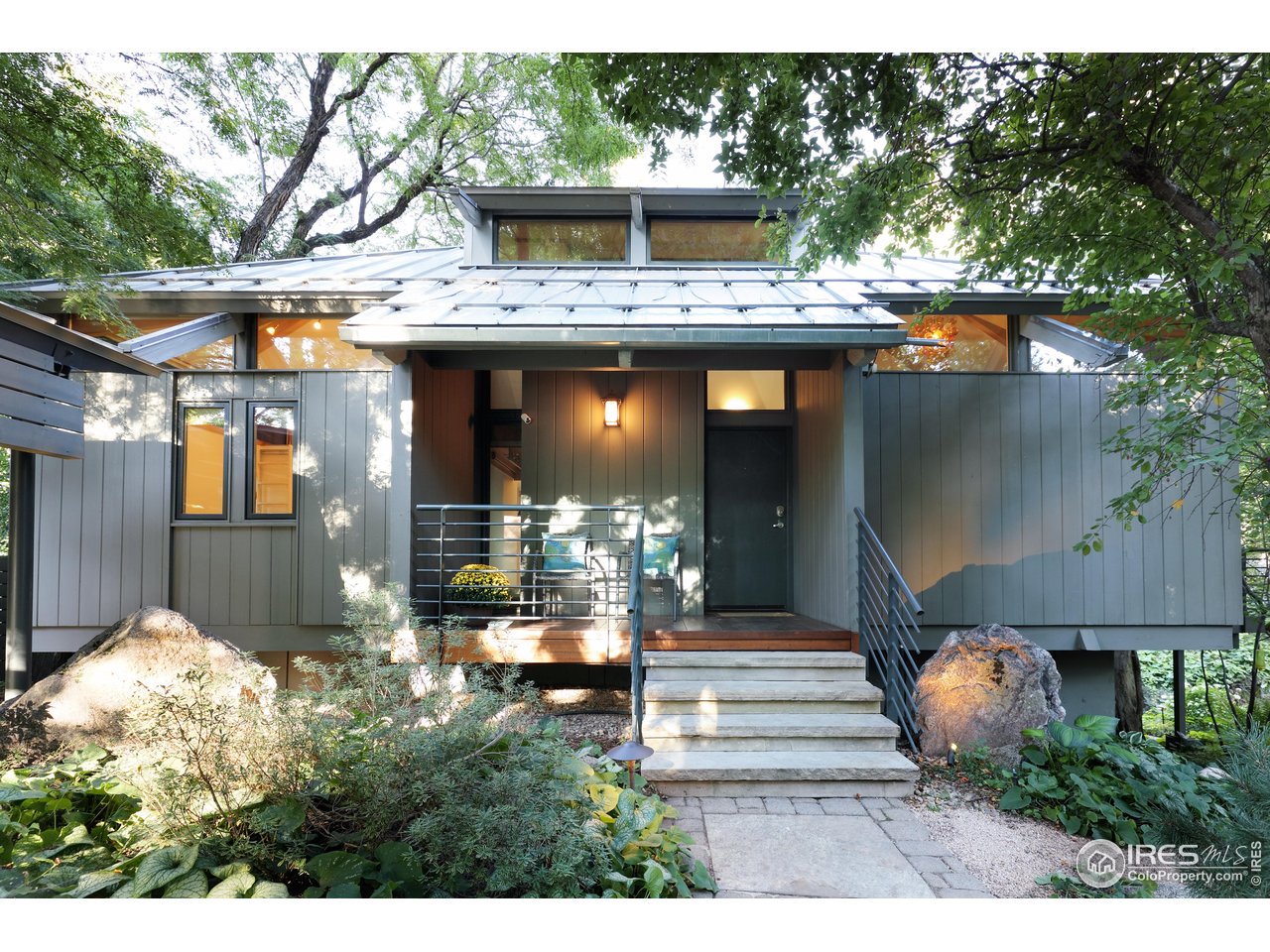 1006 6th Street Boulder, CO 80302 - Photo 2 of 40 a front view of a house with a garden