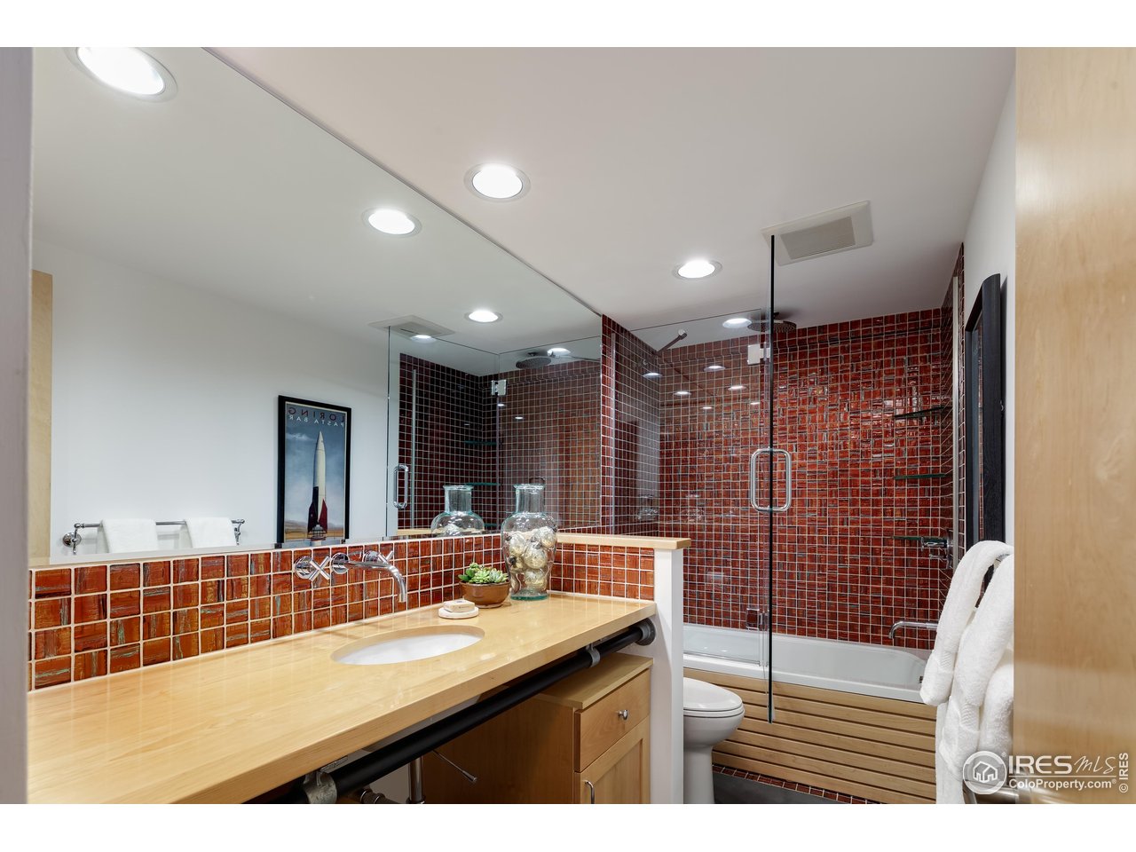 1006 6th Street Boulder, CO 80302 - Photo 22 of 40 a bathroom with a sink mirror and shower
