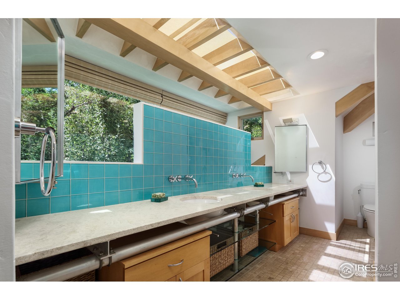 1006 6th Street Boulder, CO 80302 - Photo 25 of 40 a bathroom with a sink and a large mirror