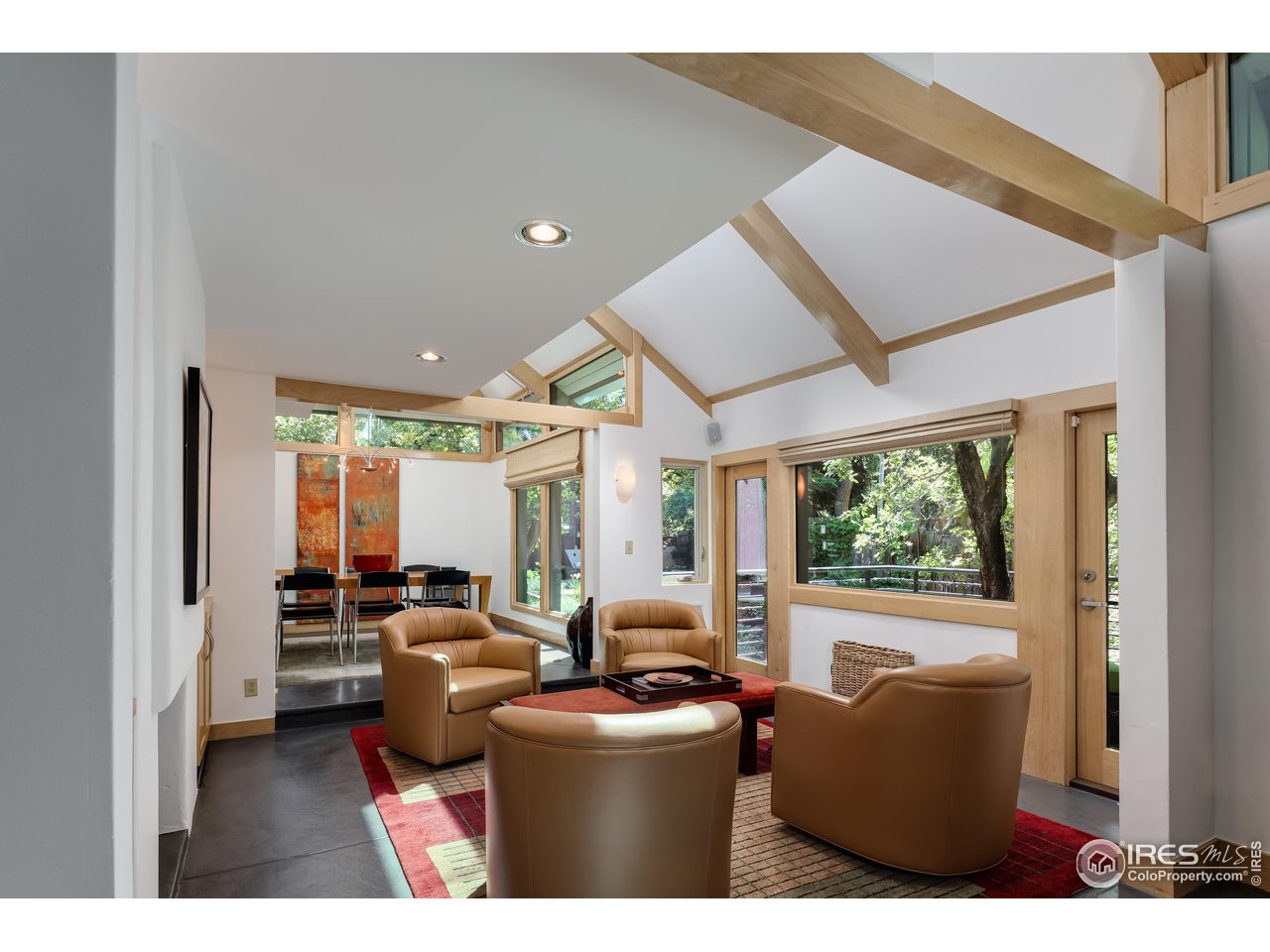 1006 6th Street Boulder, CO 80302 - Photo 6 of 40 a living room with furniture a large window and wooden floor