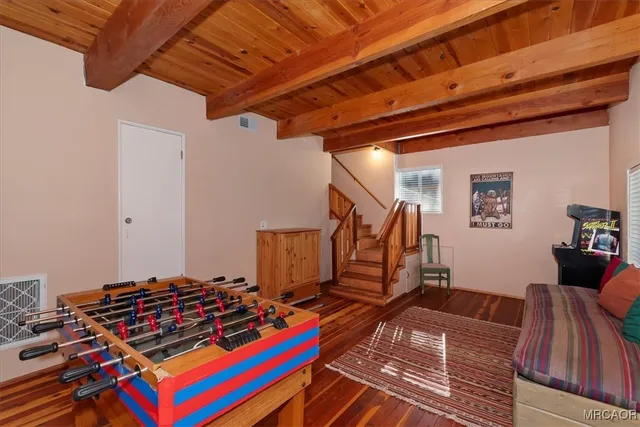 a view of gym equipment with wooden floor