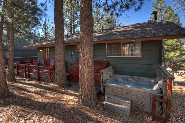 a front view of a house with a tree