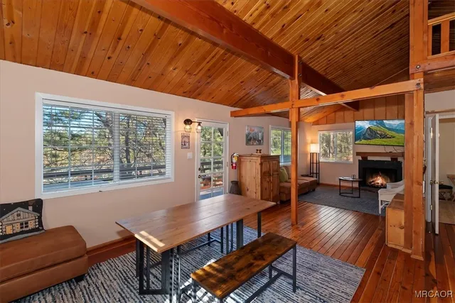 a living room with furniture a fireplace and a table