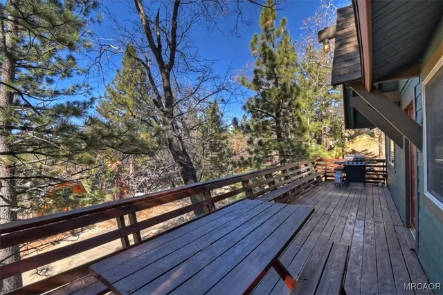 a view of balcony with wooden floor and fence